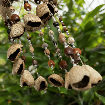 22-24 inch Forest Echo Nut Shell Chime with cascading Panji, Pudi, and Pala seeds on a rustic vine loop, organic home decor.