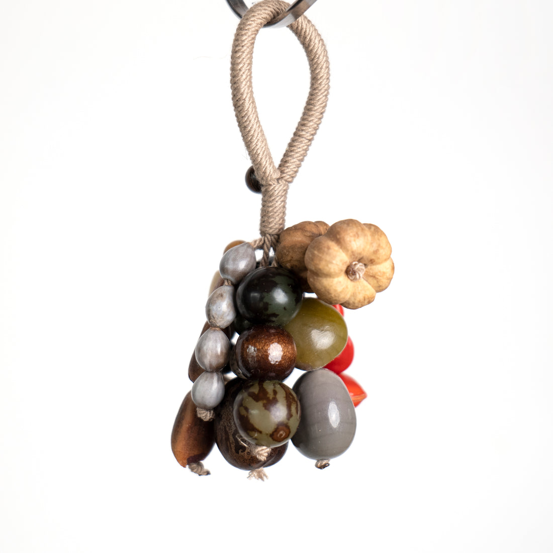 Close-up of Jade Forest seed cluster showing green Bodhi seeds, ivory bead and natural nut shells hand-knotted on hemp rope