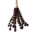 Large 96-seed Pala nut wind chime with peach pits and red beans on jute rope — flagship botanical sound healing and meditation decor
