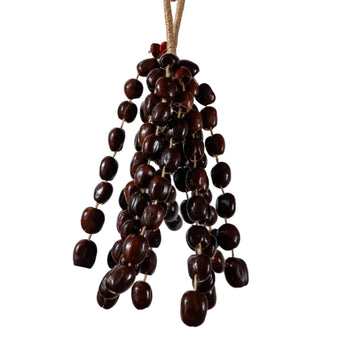 Large 96-seed Pala nut wind chime with peach pits and red beans on jute rope — flagship botanical sound healing and meditation decor