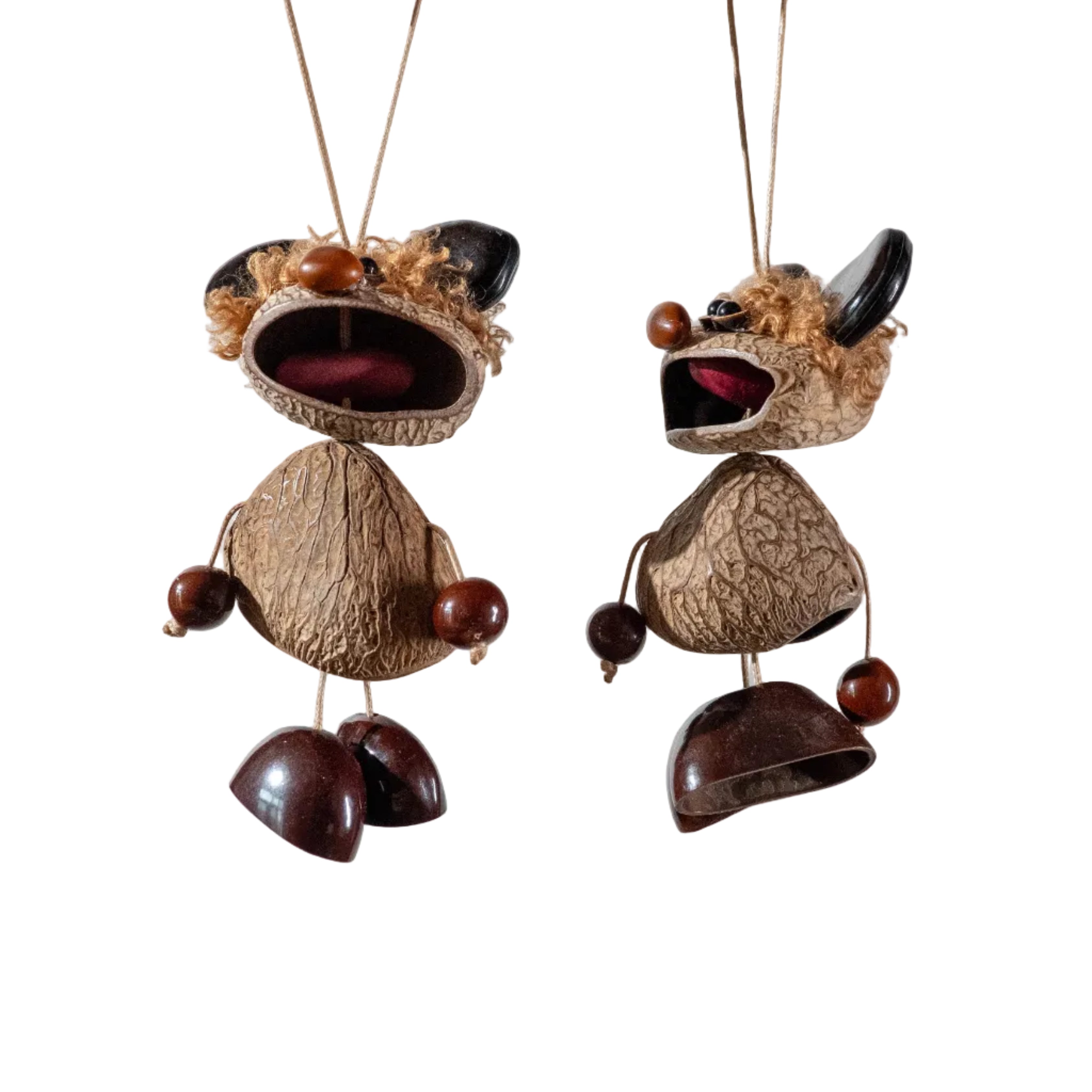 Handcrafted quirky bag charm puppet made from natural nut shells and botanical seeds, featuring a whimsical expression and earthy textures