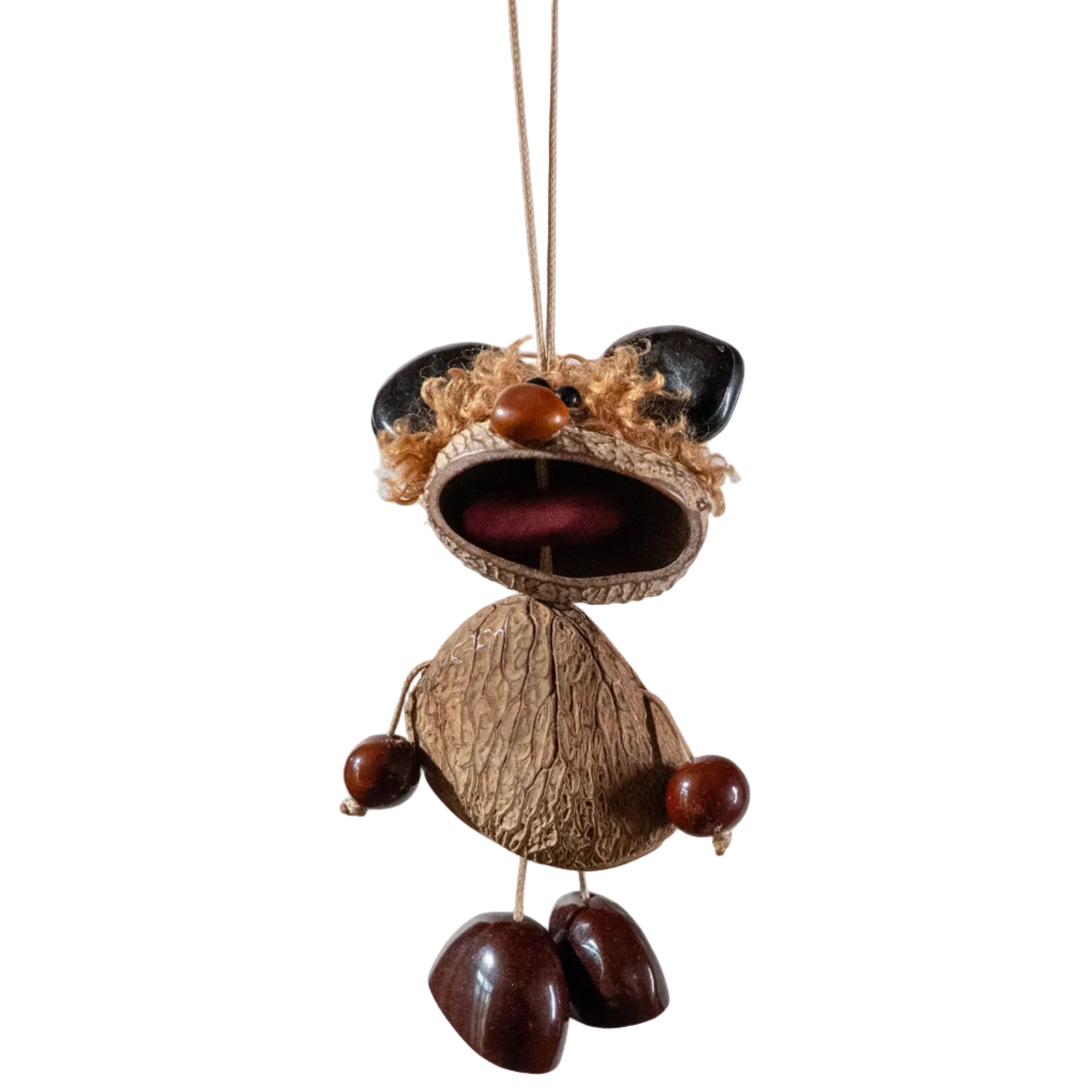 Handcrafted quirky bag charm puppet made from natural nut shells and botanical seeds, featuring a whimsical expression and earthy textures