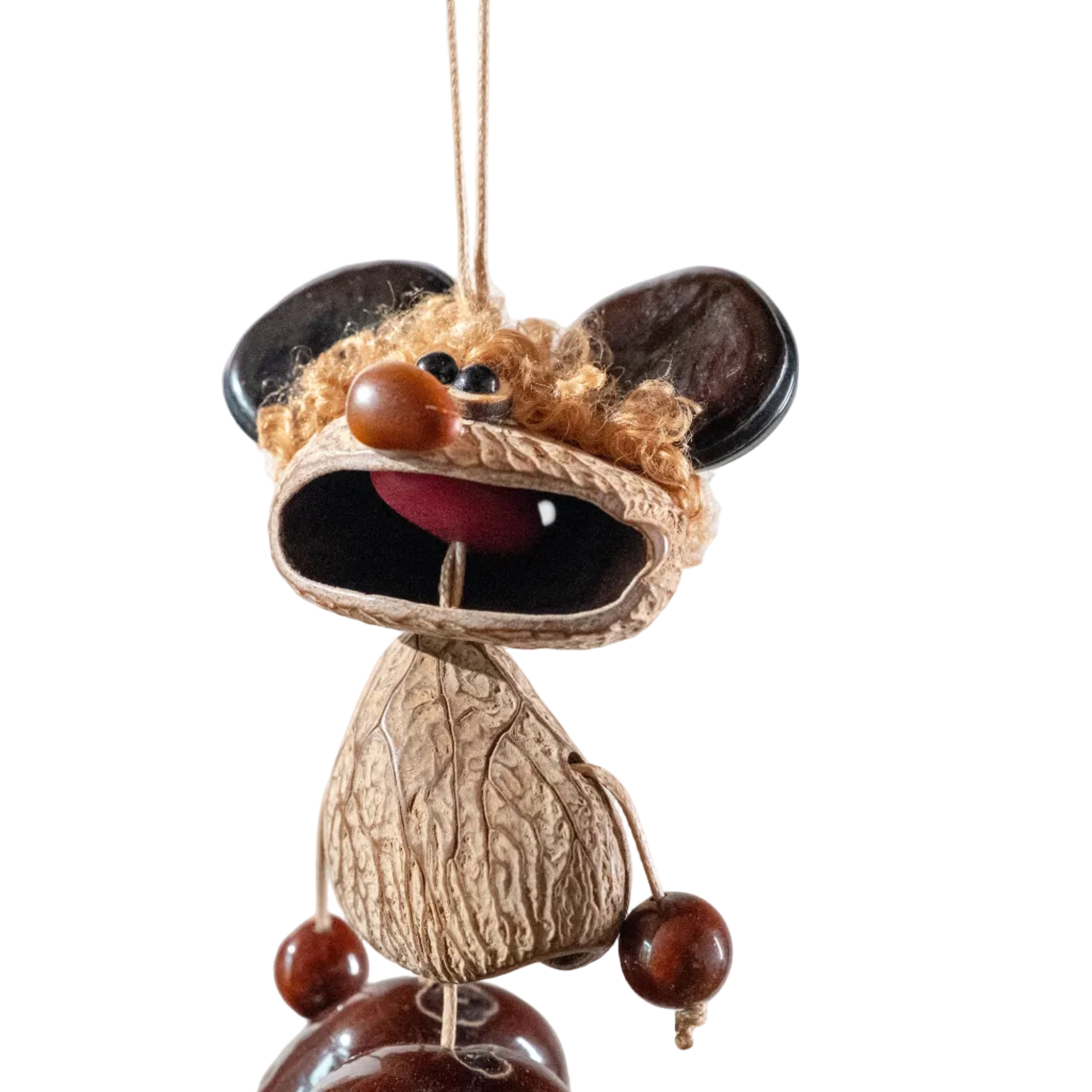 Handcrafted quirky bag charm puppet made from natural nut shells and botanical seeds, featuring a whimsical expression and earthy textures
