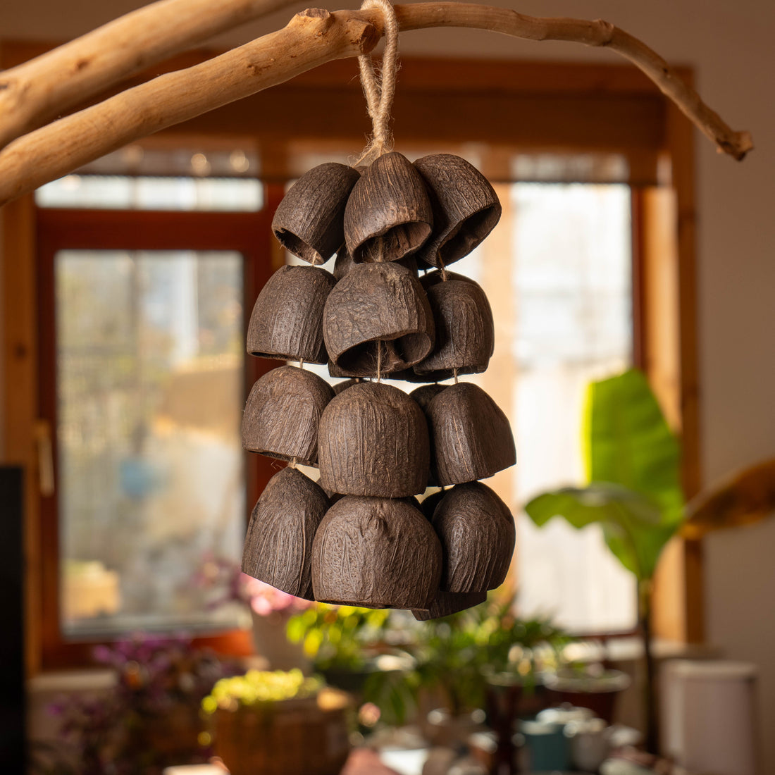 Handcrafted 24-seed Salin nut shell wind chime on jute rope in black and brown — organic ASMR sound healing and sleep decor