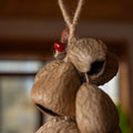 Handcrafted 10-seed Panji nut cluster door chime with red bean accent on jute rope — natural boho entryway and balcony decor