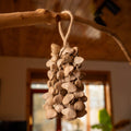 Handcrafted 74-seed Chacha shell wind chime in beige and brown on jute rope — botanical acoustic anchor for sensory grounding and sound healing