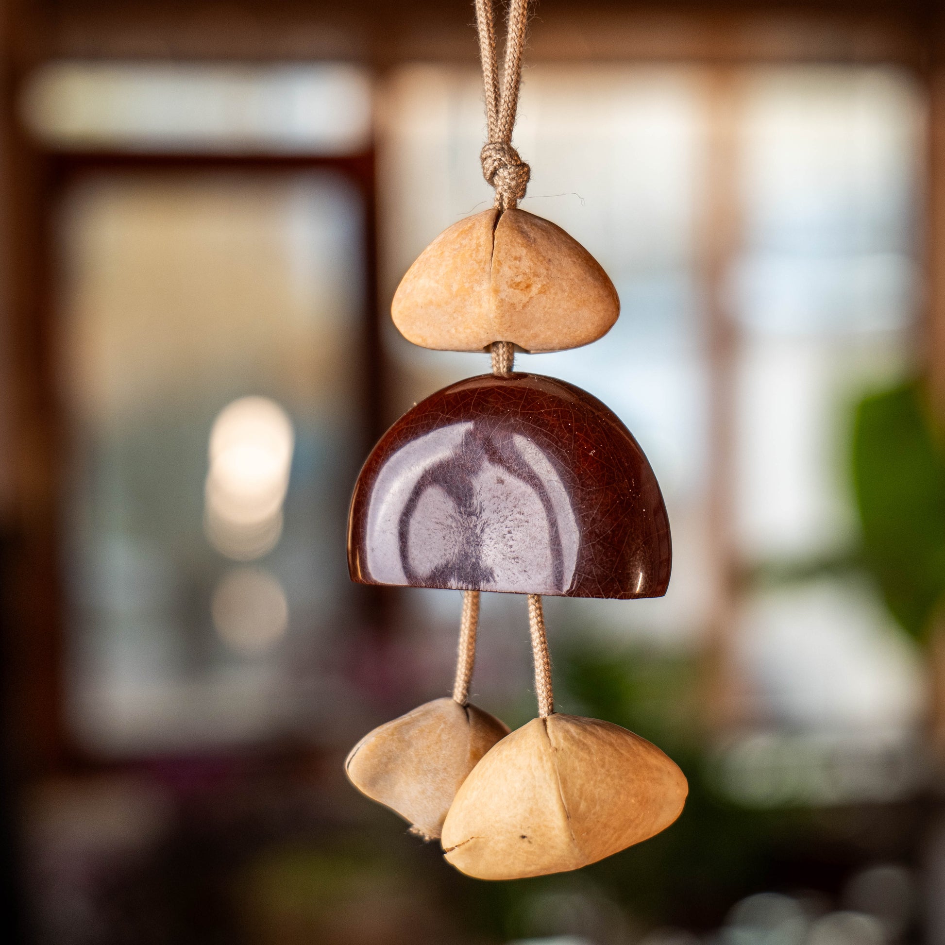Handcrafted 24-element botanical bag charm in two colorways — beige and brown nut shell acoustic accessory for handbags and backpacks