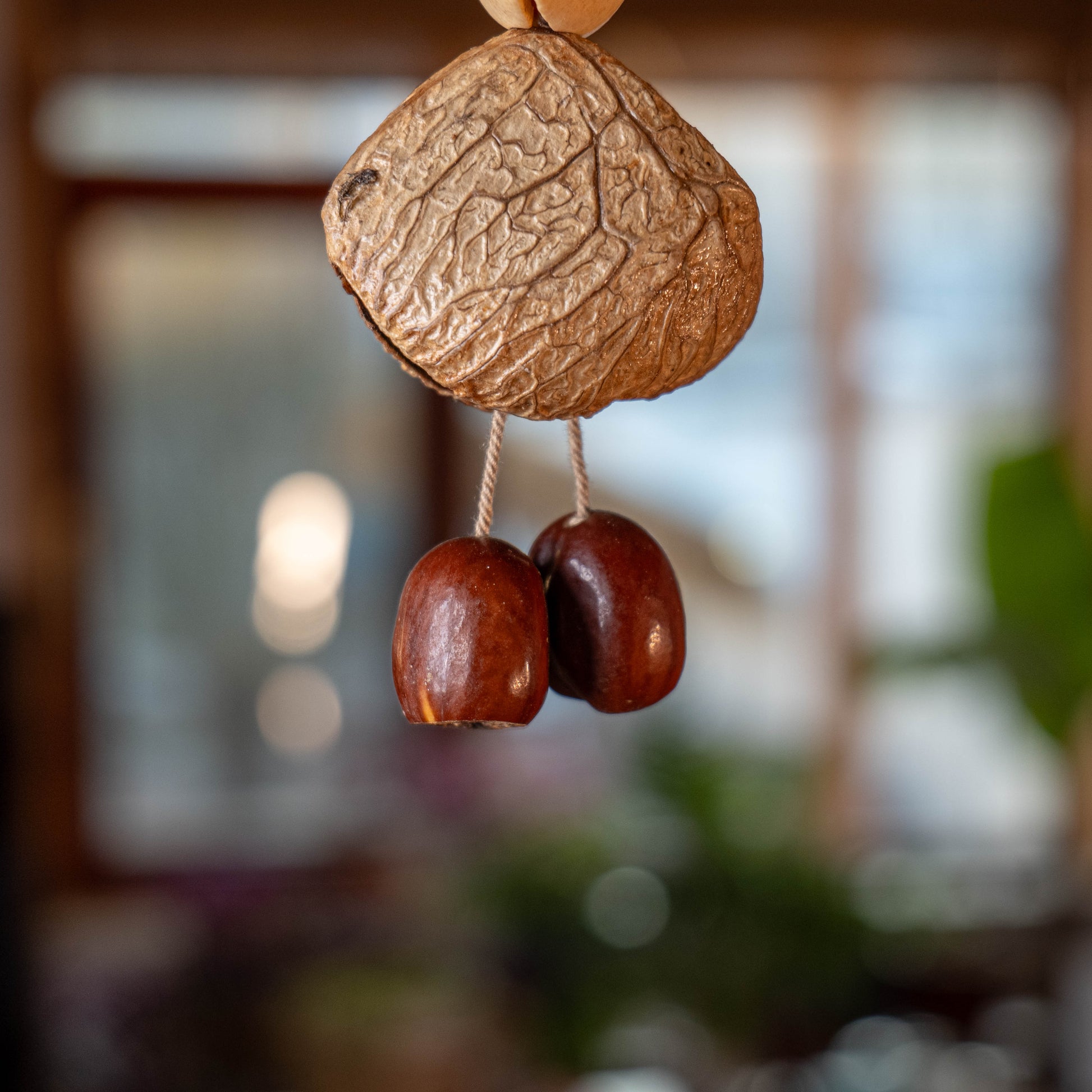 Handcrafted 24-element botanical bag charm in two colorways — beige and brown nut shell acoustic accessory for handbags and backpacks
